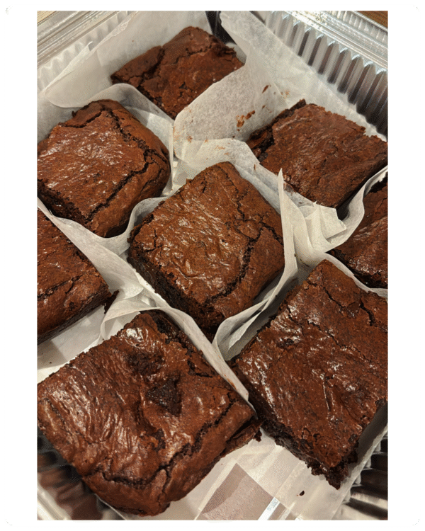 Freshly baked fudgy chocolate brownie, cut into 8 generous servings, rich and gooey in the center, served on a rustic plate — homemade with love by MumsFavouriteBakes