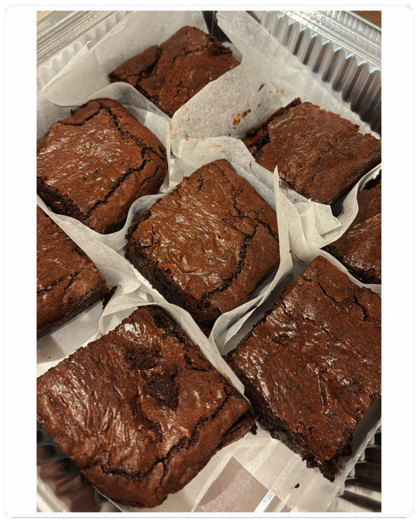 Freshly baked fudgy chocolate brownie, cut into 8 generous servings, rich and gooey in the center, served on a rustic plate — homemade with love by MumsFavouriteBakes